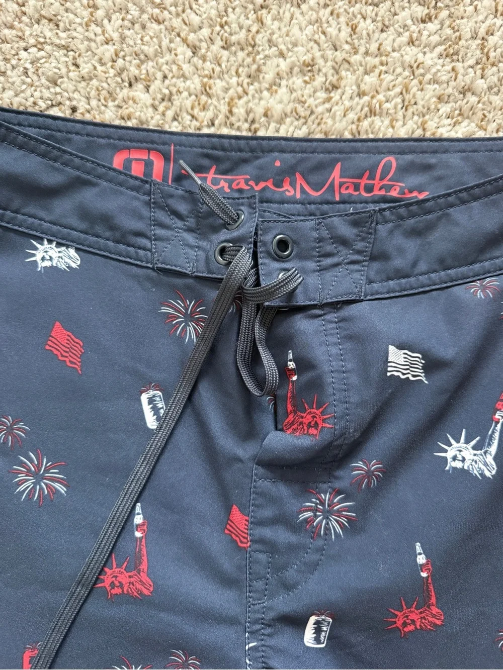 Travis Mathew Navy Swim Shorts with Red & White Liberty Icons